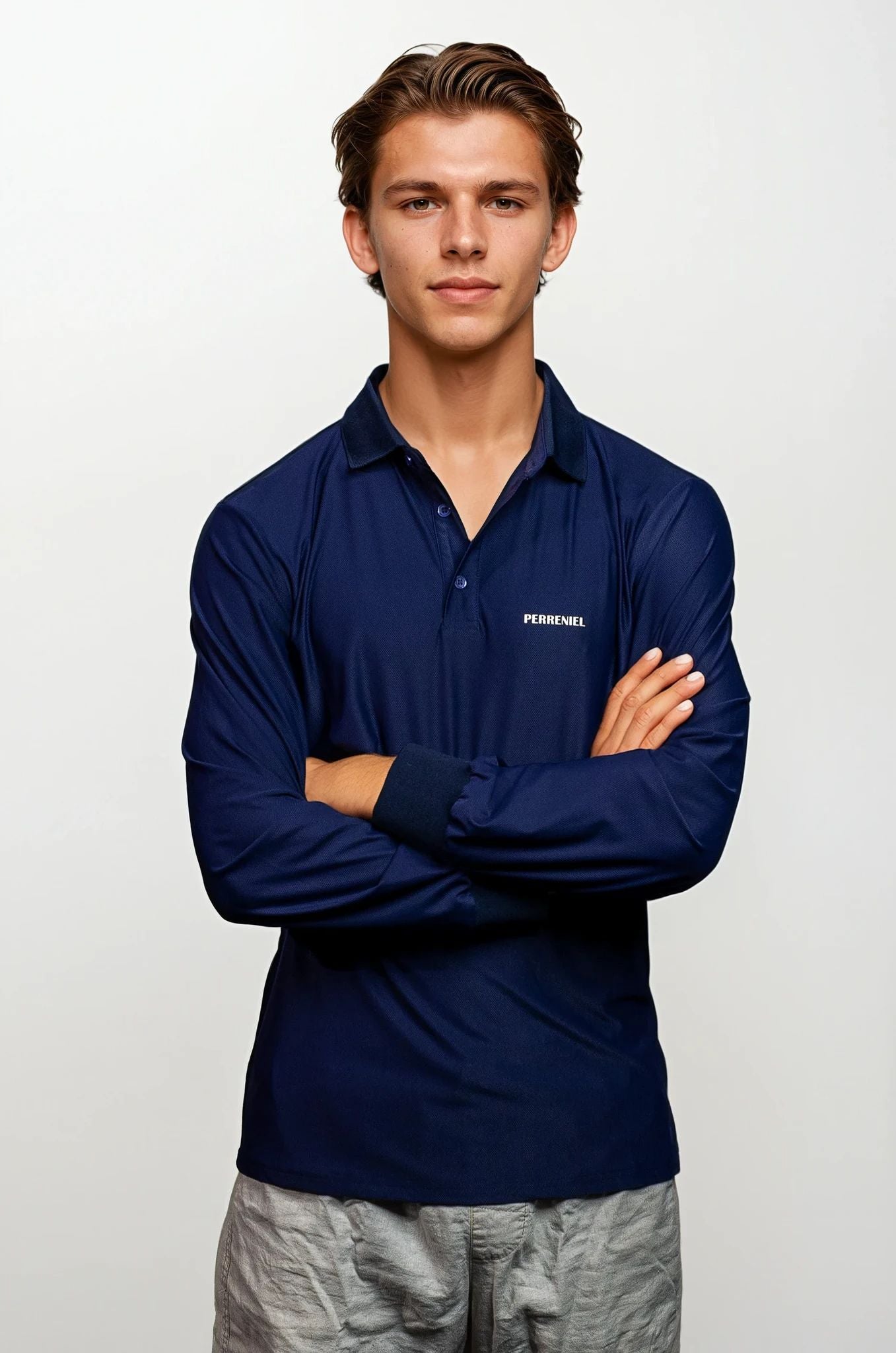 Man wearing a navy blue polo shirt with Perreniel logo on a white background