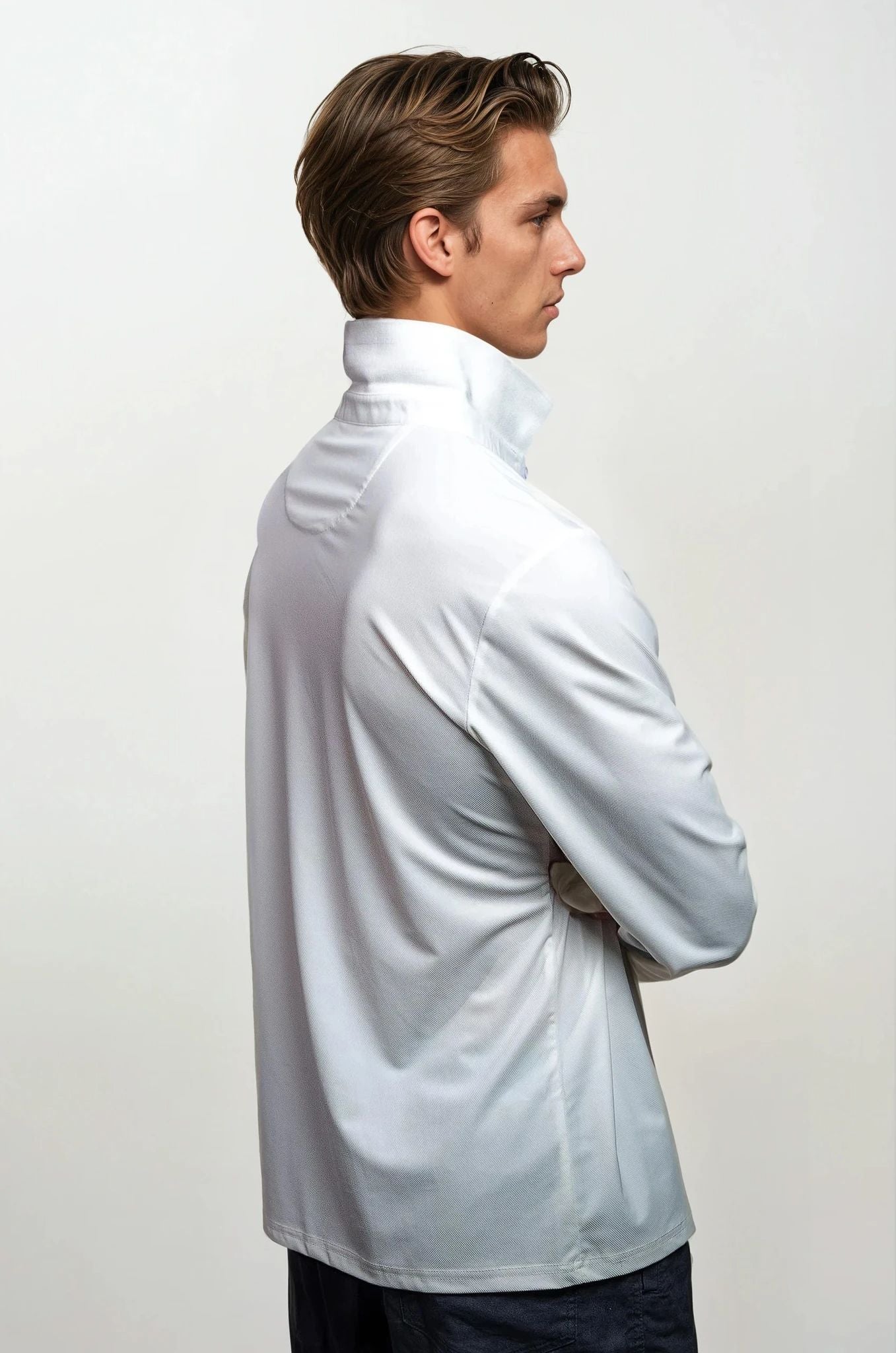 Man wearing a white shirt against a plain background