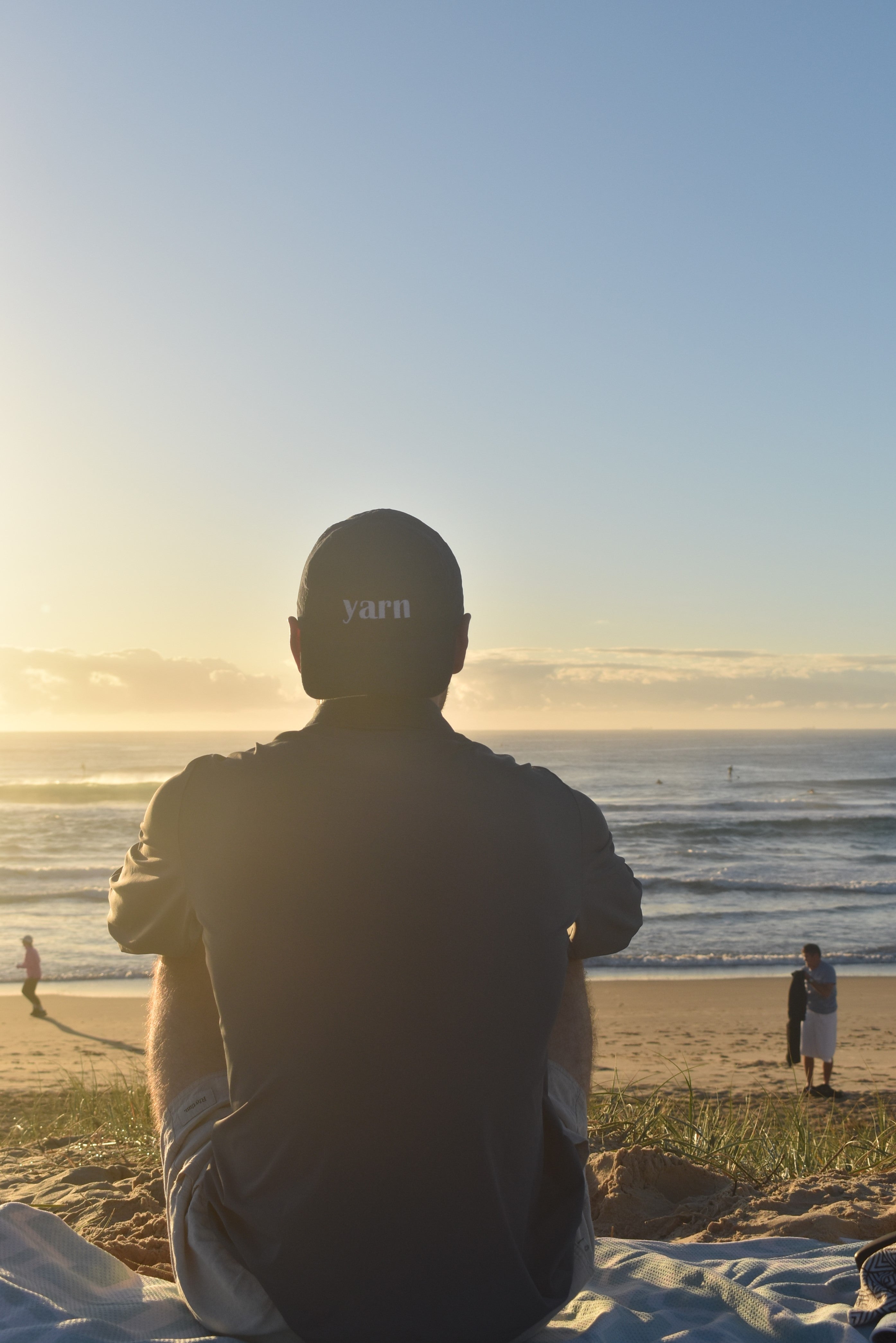 Man on beach looking at ocean wearing a Perreniel Premium Sun Tee